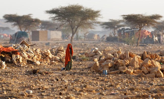 Woman walks through a Somali drought displacement camp